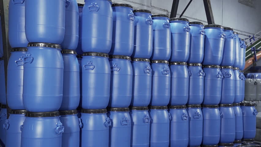 A close up group of Blue stacked Plastic chemical drums or Plastic Chemical barrels in the industrial  | Shutterstock HD Video #1104863095
