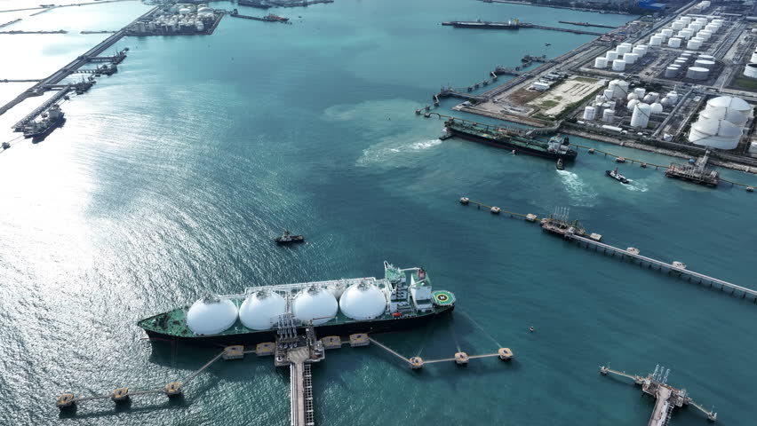 LNG (Liquified Natural Gas) tanker anchored in Gas terminal gas tanks for storage. Oil Crude Gas Tanker Ship. LPG at Tanker Bay Petroleum Chemical or Methane freighter export import transportation and | Shutterstock HD Video #1104865091