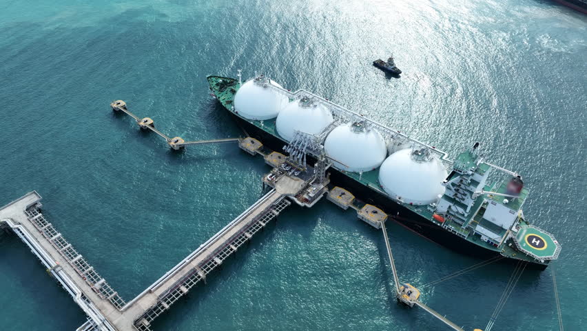 LNG (Liquified Natural Gas) tanker anchored in Gas terminal gas tanks for storage. Oil Crude Gas Tanker Ship. LPG at Tanker Bay Petroleum Chemical or Methane freighter export import transportation and | Shutterstock HD Video #1104865093