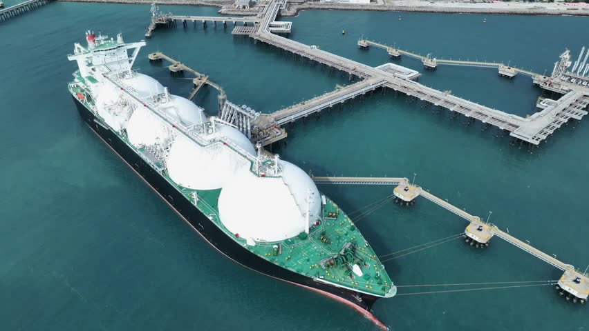 LNG (Liquified Natural Gas) tanker anchored in Gas terminal gas tanks for storage. Oil Crude Gas Tanker Ship. LPG at Tanker Bay Petroleum Chemical or Methane freighter export import transportation and | Shutterstock HD Video #1104865101