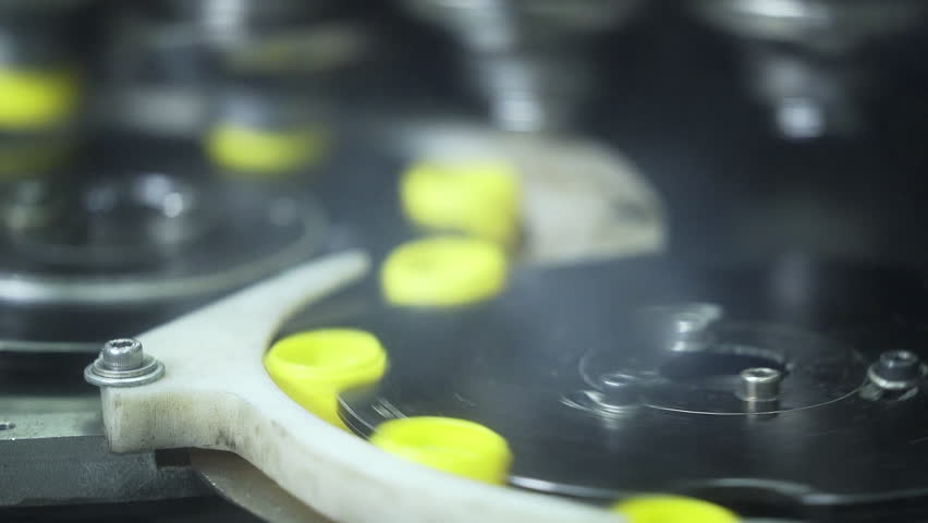 Close up of plastic bottle caps manufacturing in a automatic machine. | Shutterstock HD Video #1104866163