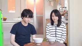 Young couple eating dinner at home together