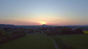 sunset czech republic village castle on hill Smooth aerial top view flight drone