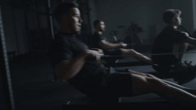 Active Training On Rowing Machine, Three Professional Sportsmen Exercising Together, Moving Shot - Powered by Shutterstock - Get 15% off with code: PIKWIZARD15