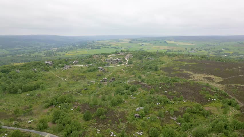 This aerial drone video shows the Brimham Rocks from above. The Brimham Rocks is a natural stone formation in the Yorkshire Dales National Park, England. These beautiful rocks are found in the moor. 