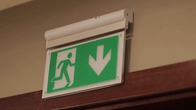 Exit icon, close-up. Direction to the emergency exit. a green light sign indicating the direction of movement to the emergency exit in the room. green emergency exit sign above a door in a interior. - Powered by Shutterstock - Get 15% off with code: PIKWIZARD15