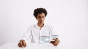 Male laboratory scientist monitoring virus modification on holographic tablet. Futuristic technology on white background - Powered by Shutterstock - Get 15% off with code: PIKWIZARD15