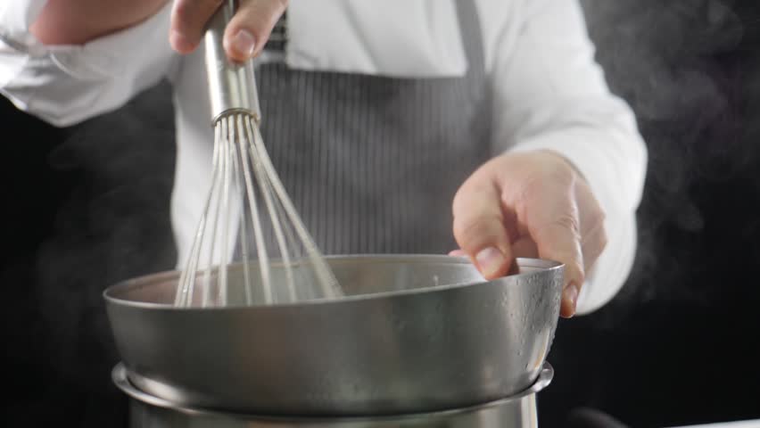 Chef using cooking egg whisk in slow motion. Preparing ingredients for healthy cooking. Homemade food. Delicious Recipe Kneading Dough. Home Cooking Pancake Bakery Preparation. Mixing Dough Whipped Royalty-Free Stock Footage #1104880693