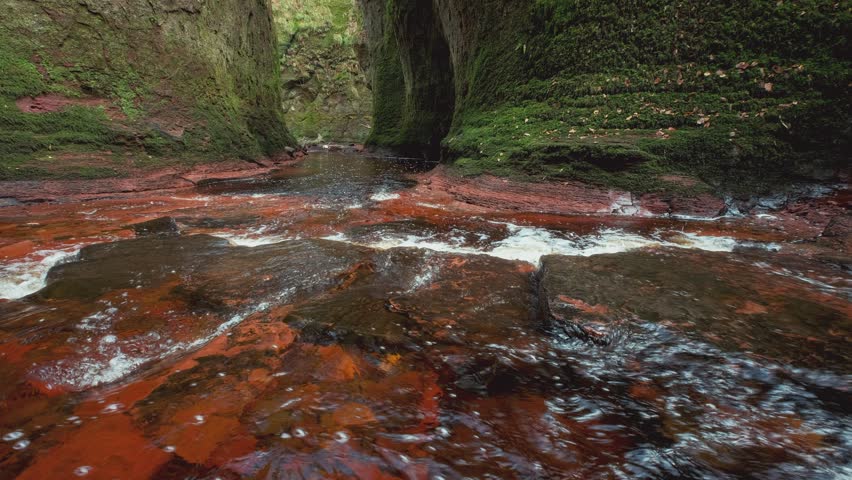 A river inside of the Devils Pulpit gorge. 4k video. Finnich Glen, Scotland, UK