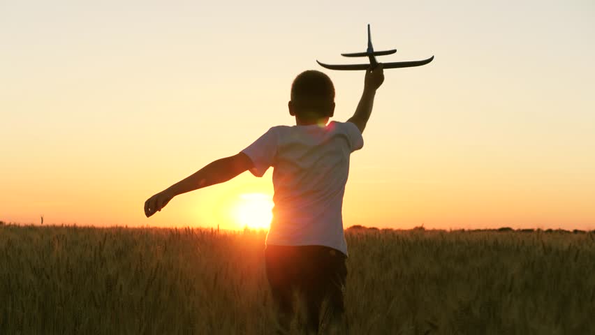 Boy teenager child kid runs through field with wheat with toy plane his hands sunset, happy dream family, airplane soars wind child hand, dream concept, astronaut, child runs wheat field, happy child | Shutterstock HD Video #1104883987