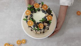 cook a cake in the kitchen. Young female pastry chef cooking a beautiful high sponge cake, pastry chef works at home, bright kitchen, video of the process