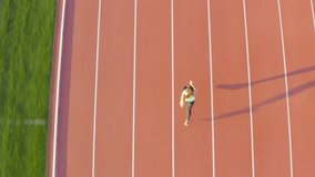 Caucasian female athlete alone on the athletic track, sprint running in line four, aerial directly above view. - Powered by Shutterstock - Get 15% off with code: PIKWIZARD15