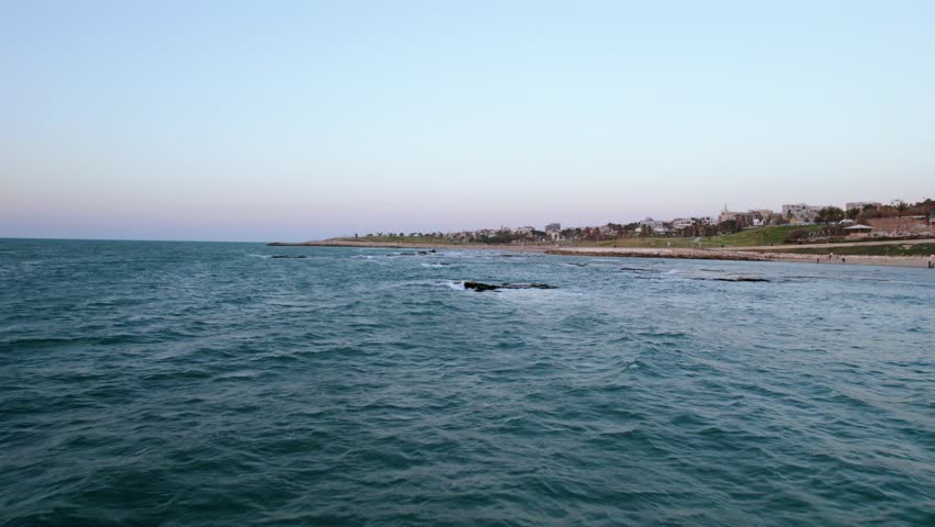 Aerial shot over the sea with rock beach is Bat Yam, Tel Aviv, Israel