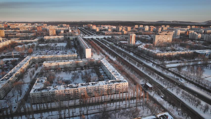 Aerial view. Winter panorama of the city of Tolyatti in the Samara region. Snow-covered streets of a provincial and industrial Russian city. Royalty-Free Stock Footage #1104897309