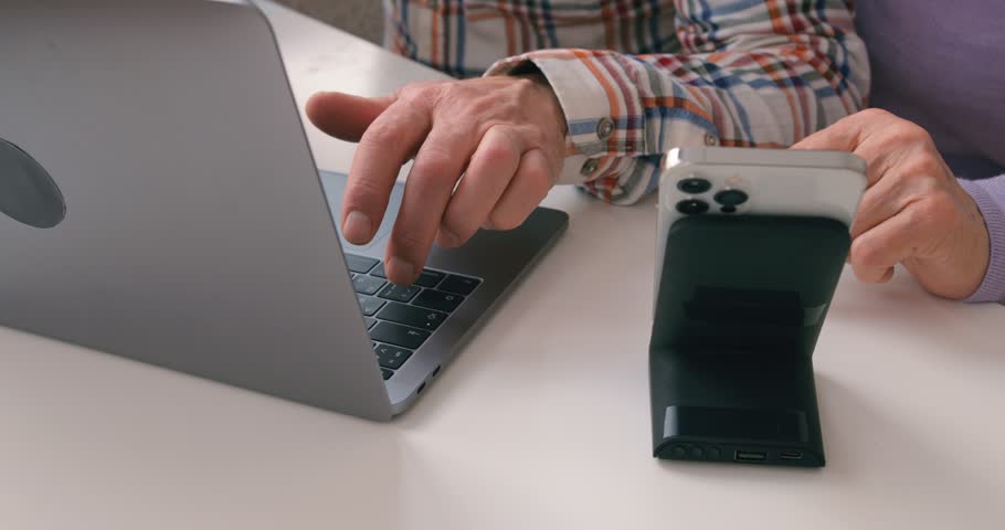 old female and male hands usinf modern technolodies, gadget, generation Slow motion Senior couple using laptop and smart phone at home