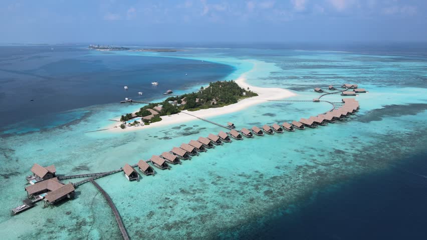 Camera drone flies toward Makunufushi Island with a hotel resort, Maldives Royalty-Free Stock Footage #1104899367