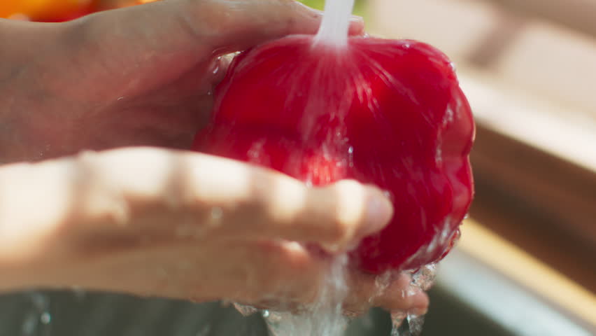 Close up of asian woman Hands Washing Red Bell Pepper in the Kitchen Sink. Woman washing vegetables by hand prepare for cooking. Washing healthy Vegetables Natural and Organic Product for cooking. Royalty-Free Stock Footage #1104900291