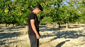Young man praying outdoors videos, starting to perform the salaah, worshiping in nature, verse of the Quran, with the meaning In the Name of Allah, the Most Beneficent, the Most Merciful