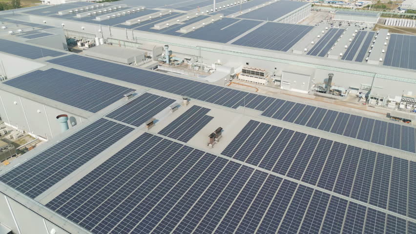 Aerial view of solar panels or solar cells on the roof of factory building rooftop. Power plant, renewable clean energy source. Eco technology for electric power in industry. Royalty-Free Stock Footage #1104904591