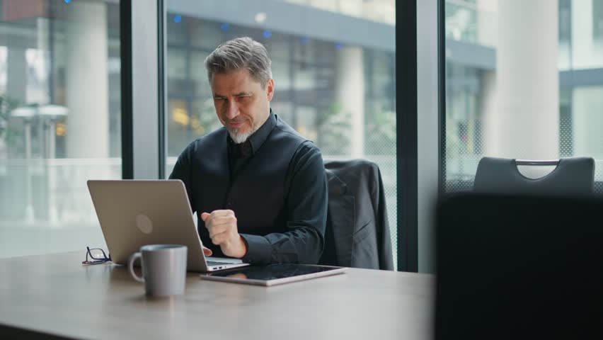 Business portrait - businessman using laptop computer in office. Happy middle aged man, entrepreneur working online. Royalty-Free Stock Footage #1104910399