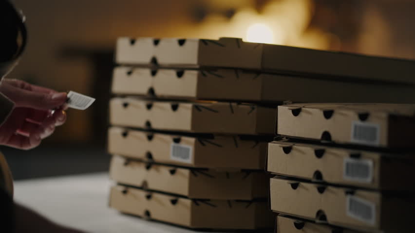 Italian restaurant, Chef baker cooks Responsibly Glue barcodes pizza box Specialized bakery shop Close-up of Professional chef assistant Serves customers in fast food restaurant kitchen Chef