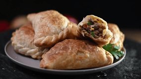 Savory Whirlwind: Enchanting Slow Motion Video of 6 Traditional Argentinian Empanadas with Meat, Vegetables, and Egg, Dancing on a Plate