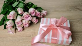 closeup female hands holding box with gift, bouquet of white, pink roses, box with gift with satin ribbon, flowers for professional holiday, concept of mother's, Valentine's day, birthday - Powered by Shutterstock - Get 15% off with code: PIKWIZARD15