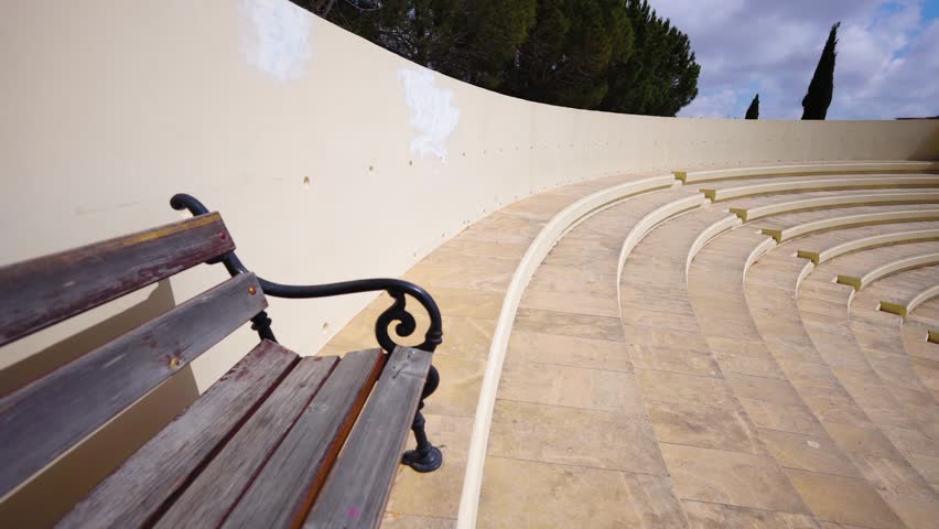 Beautiful 4K time-lapse from inside an amphitheater located on a mountain. The sea is visible on the horizon. Drifting clouds create a unique atmosphere. The camera pans from left to right.