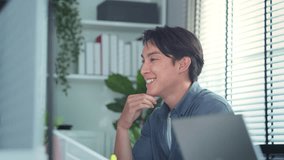 Smiling asian man working on laptop computer in office, happy male with review of investment profit, trader crypto bitcoin, nft or forex. - Powered by Shutterstock - Get 15% off with code: PIKWIZARD15