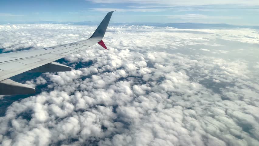 stunning airoplane window views and airplane wings in flight. airplane, airports, and airliner window stock footage. spectacular views of aeroplane wings and Cloud scapes Royalty-Free Stock Footage #1104926245