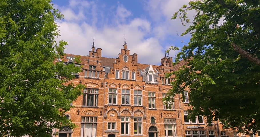 Establishing shot. Landmarks of Belgium architecture. People and tourists are walking. Gothic buildings in the background