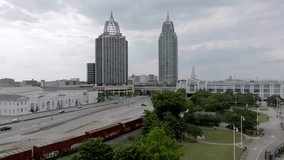 Train moving in downtown Mobile, Alabama with stable drone video.