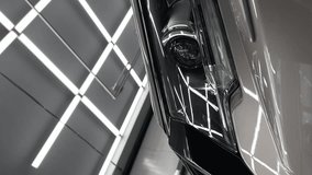 Headlight of Grey mirror premium car in the detaling studio after polishing. High quality FullHD footage.Vertical video