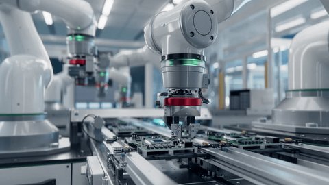 Advanced High Precision Robot Arms at Bright Electronics Factory. Fully Automated Modern PCB Assembly Line. Component Installation on Circuit Board. Electronic Devices Production Industry. Stockvideó