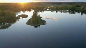 A small island in the middle of the dam lake in Ao Estonia on a sunset spring day. Camera moves slowly forward. geology shot