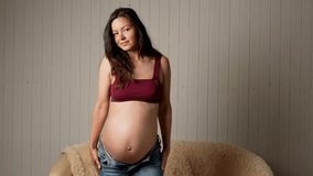 Pregnant woman dancing with big belly. Happy pregnant woman. Pregnancy, motherhood, people and expectation concept