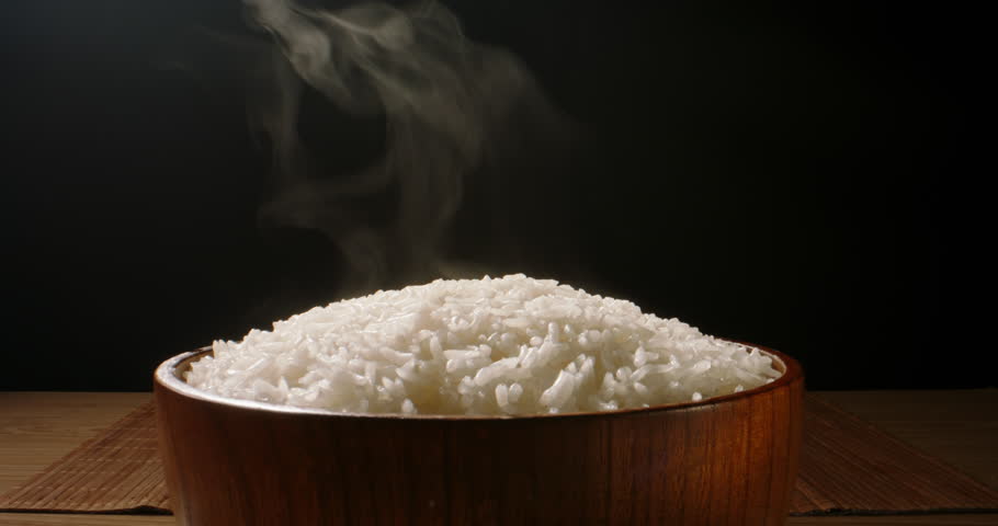 Hot white cooked rice steam bowl black background slow motion, Close up. Sticky rice after cooked. Asian Chinese Thai Japanese Indian cuisine. Ingredients of Slow and calm oriental lifestyle Royalty-Free Stock Footage #1104933435