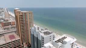 Gulf Shores, Alabama skyline and beach with drone video moving in close to hotel.