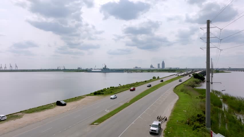 Wide view of freeway traffic on US 10 Battleship Parkway in Mobile, Alabama with drone video stable.