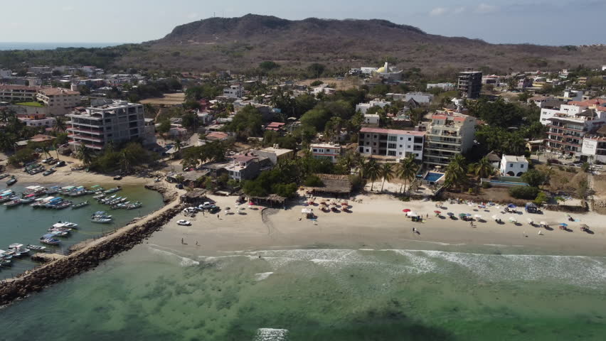 An aerial of a fishing village and the shore in Punta Mita, Puerto Vallarta Mexico on a sunny day