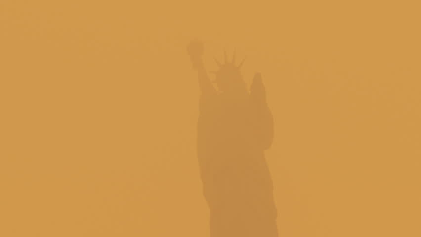 The Statue of Liberty in New York City covered in the smoke from the Canadian wildfires. Orange sky. Royalty-Free Stock Footage #1104938523