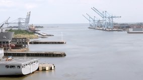 Shipyard and ships in Mobile Bay in Mobile, Alabama with close up parallax view and drone moving right to left.