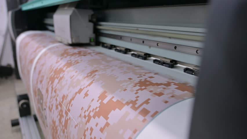 Industrial sublimation printer for digital printing on fabrics. Modern textile industry. Textile printing is the process of applying colour to fabric in definite patterns or designs.