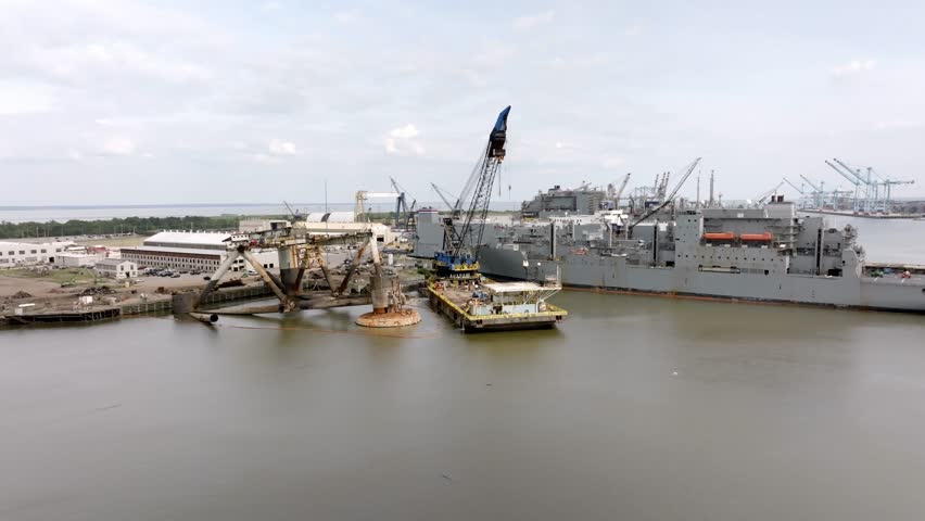 Ships and shipyard in Mobile Bay in Mobile, Alabama with drone video moving left to right.