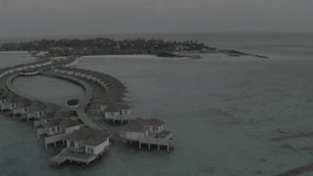Aerial view of a bungalow villa on the water. Aerial drone footage of an exotic turquoise paradise in the tropical Maldives. High quality 4k video. A luxury resort in the Maldives. Footage without col