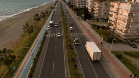 Serene Coastal Drive: Cinematic Drone Films the Tranquil Road Traffic Along the Mediterranean Shoreline