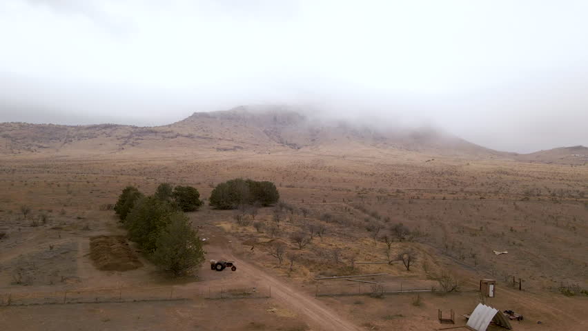 Aerial Shot Through Desert with Low Hanging Clouds in Big Bend National Park, USA. 4K Drone Footage. Drone Shot raining day in a West Texas Dessert.