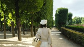Attractive girl walking in the garden in Paris