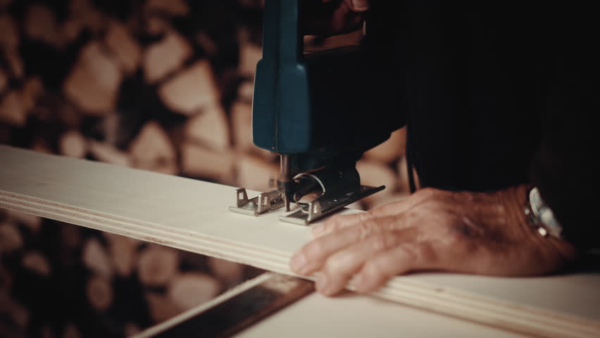 A slow motion of a carpenter cutting wood with a special machine, an Industrial Video by Wirestock Creators