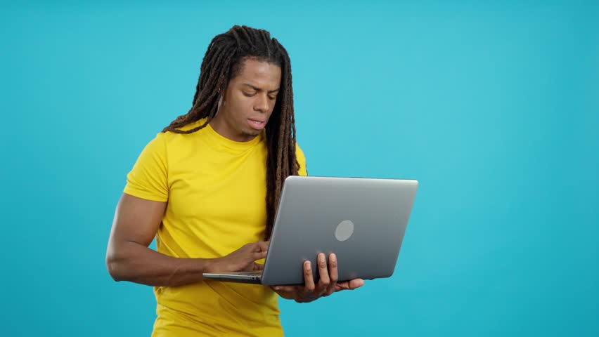Latin man with dreadlocks having a problem with a laptop Royalty-Free Stock Footage #1104949555